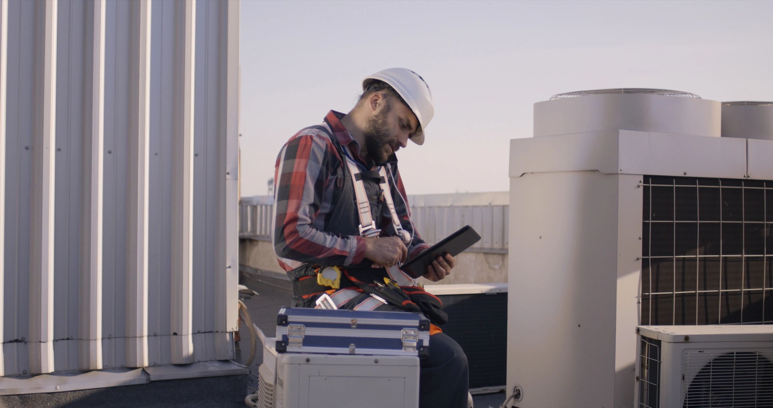 HVAC professional reviewing system performance during a maintenance visit
