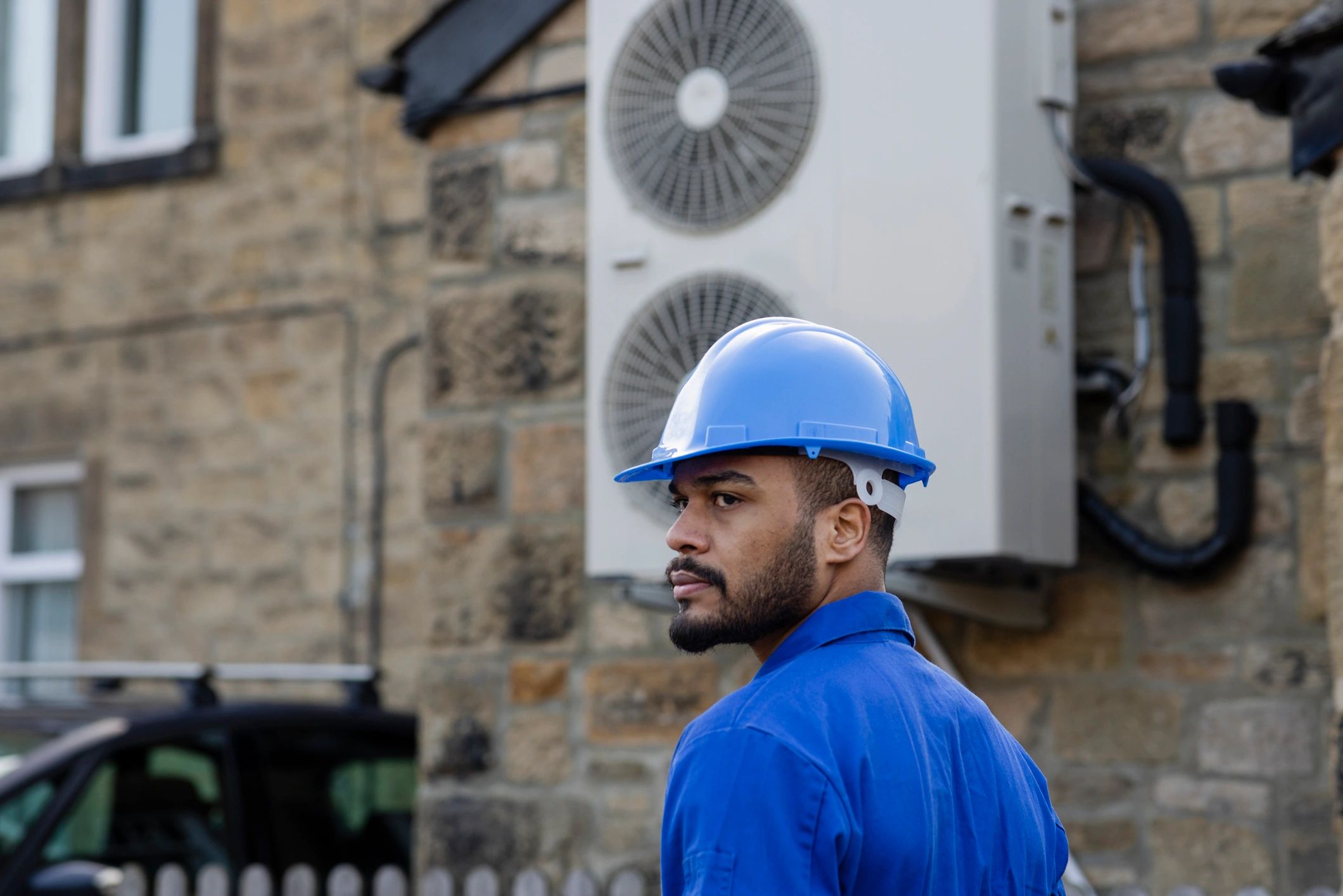 HVAC technician servicing an outdoor home comfort system