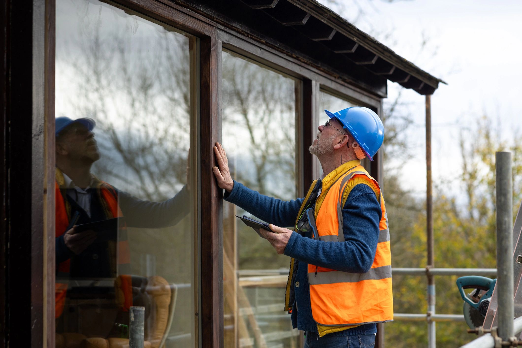 Male technician performing a residential maintenance inspection at a home