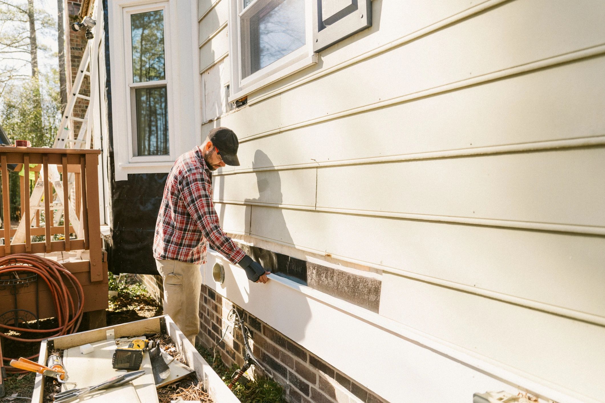 Technician working on the exterior of a home