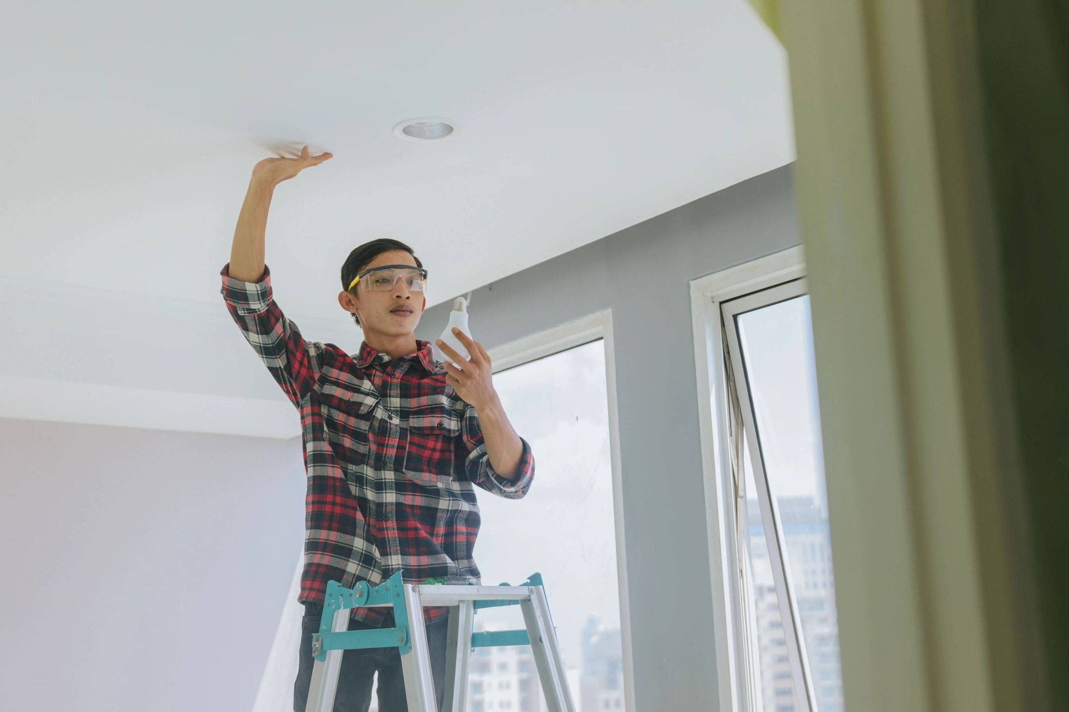 Male service technician working on a residential cooling system inside a home